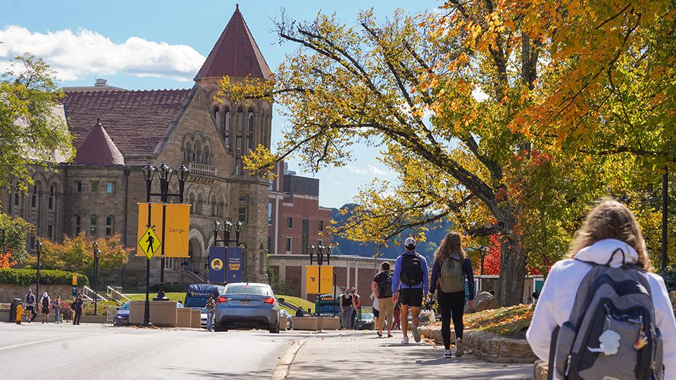 Students walk on the University Ave. sidewalks on the Downtown campus near Woodburn