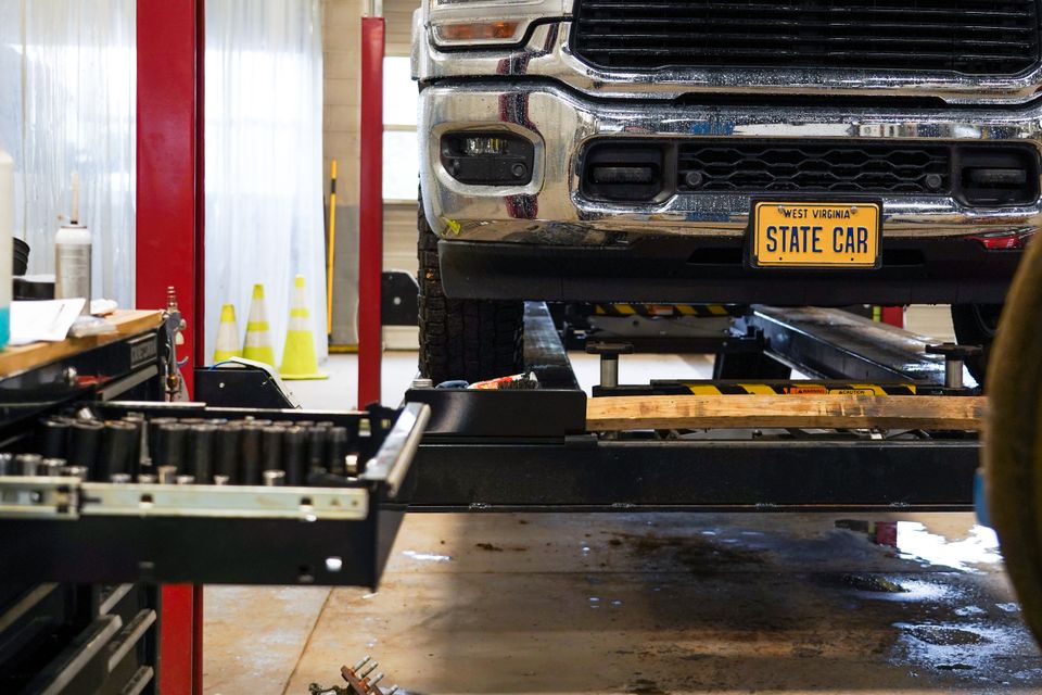 A state-owned fleet truck lifted for maintenance